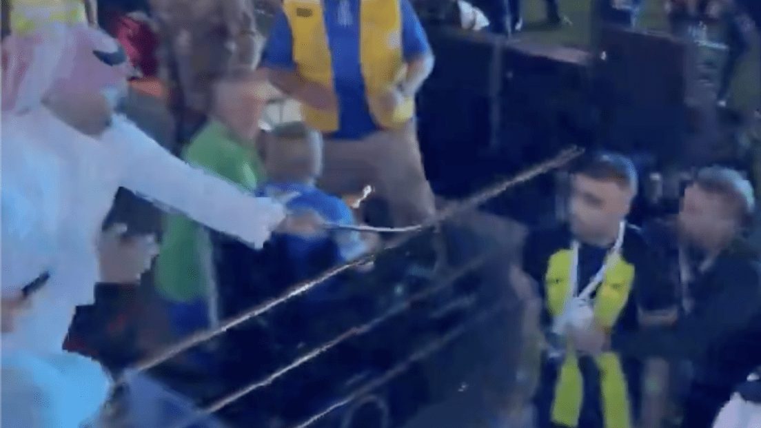 Screenshot from video of a fan striking a soccer player with a whip